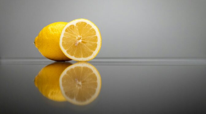 a couple of lemons sitting on top of a table
